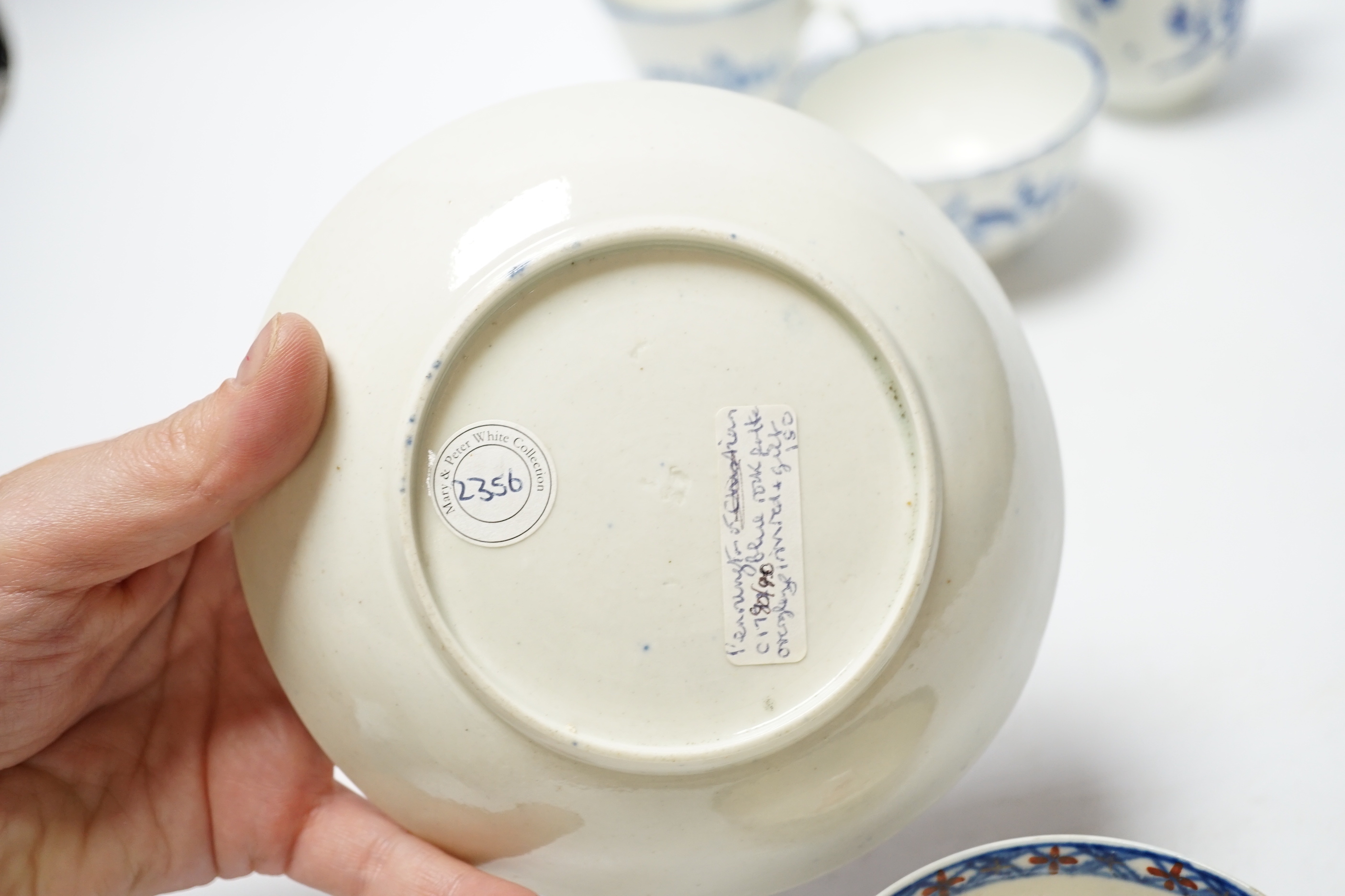 A Worcester James Giles decorated coffee cup, c.1765-70, a Caughley reeded tea bowl, a Pennington tea bowl and saucer and a coffee cup, tallest cup 6.5cm (4)